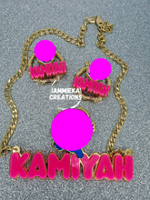 Load image into Gallery viewer, Necklace with matching earrings featuring a character design and &#39;Kamiyah&#39; text on a gray background.
